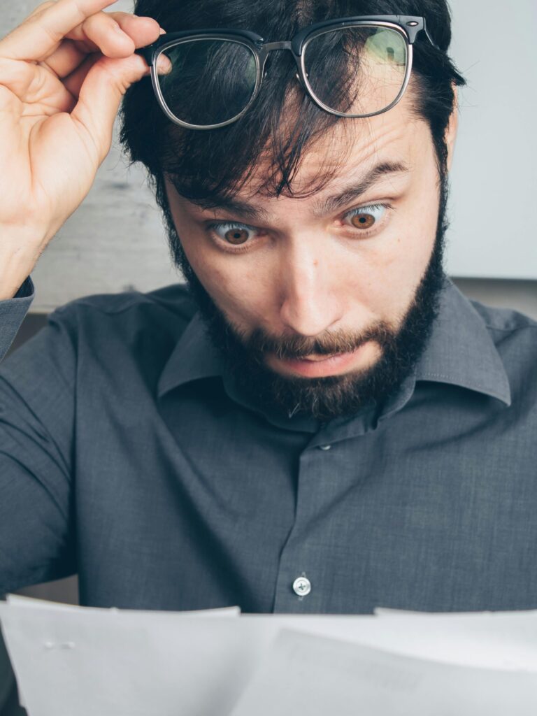 Surprised man reviewing financial documents, highlighting ConnectWise agreement profitability mistakes