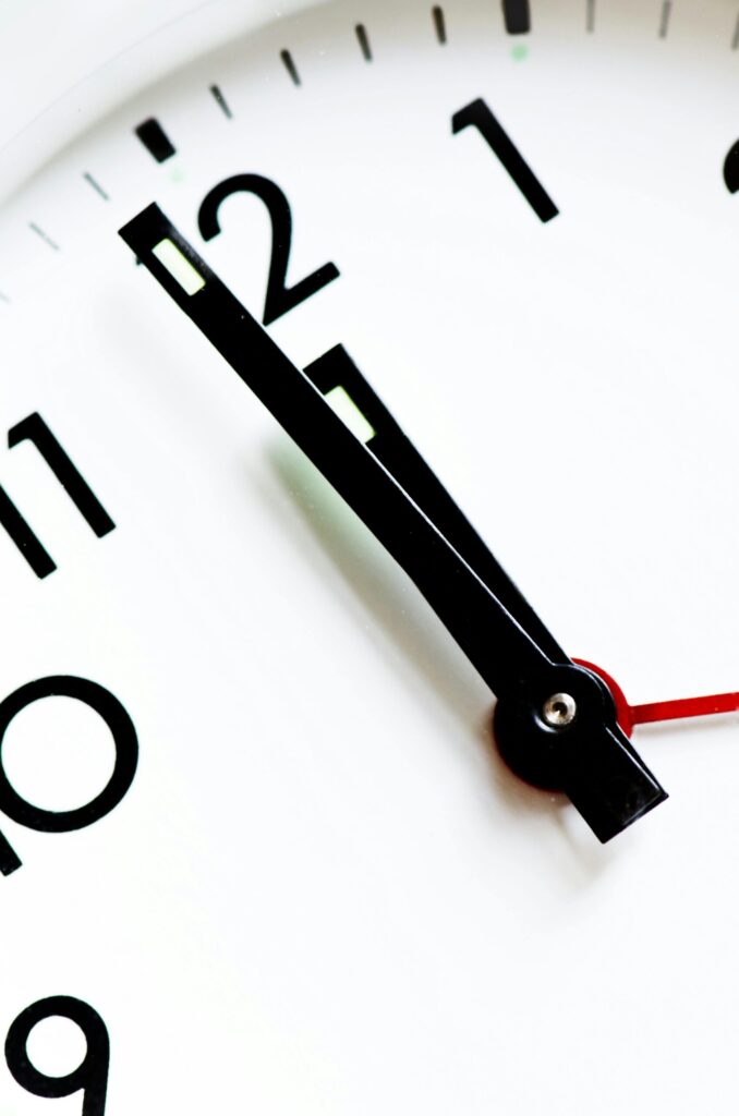 Clock striking midnight with checklist overlay symbolizing year-end preparation.